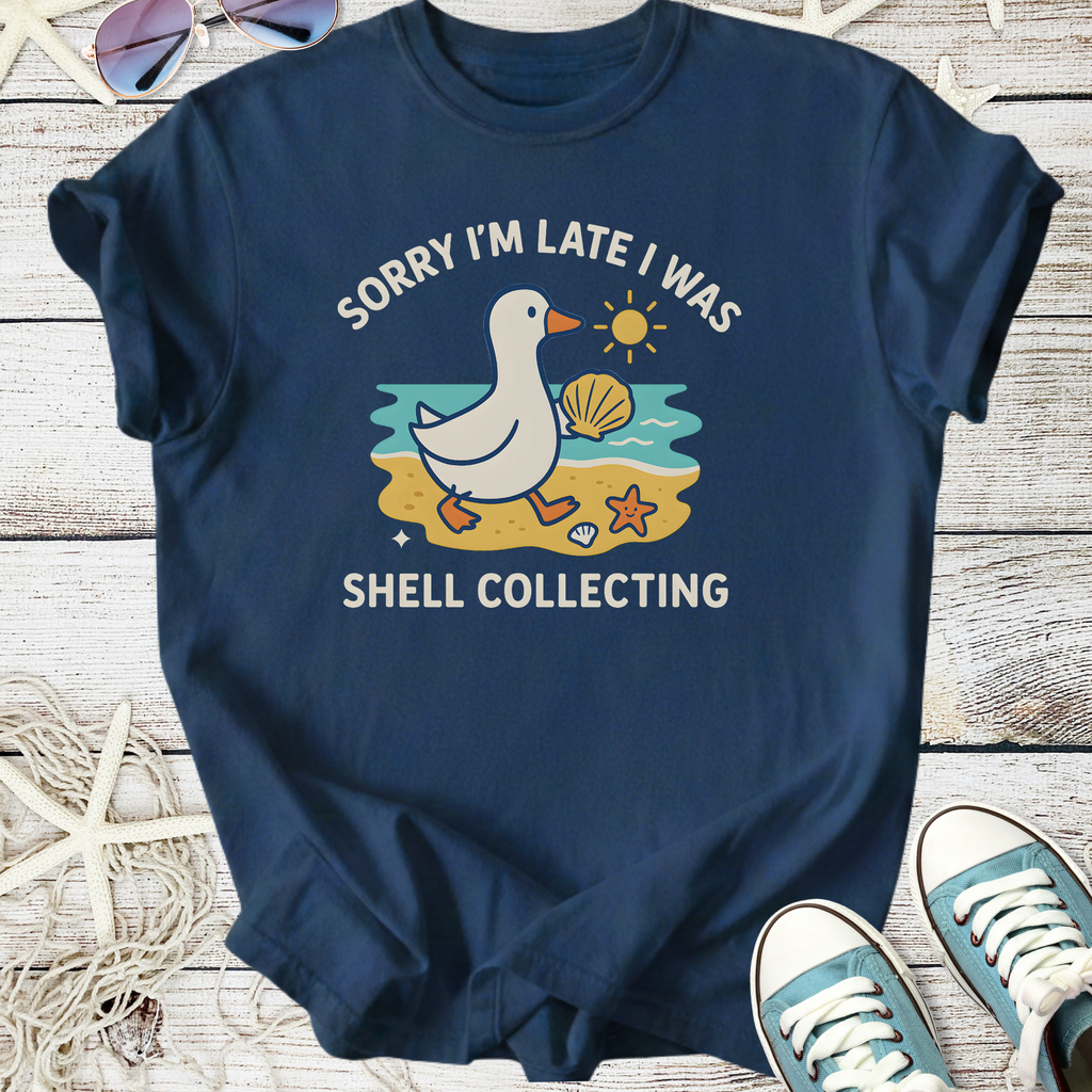 Navy blue t-shirt featuring a duck graphic with the text 'Sorry I'm late I was shell collecting'.