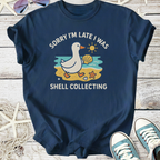 Navy blue t-shirt featuring a duck graphic with the text 'Sorry I'm late I was shell collecting'.