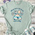 Mint green t-shirt featuring a beach-themed dog paw graphic and the phrase 'All you need is the beach and a dog'.