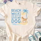 Peach t-shirt with 'Beach walks are better with my dog' graphic, featuring a golden retriever and palm tree.