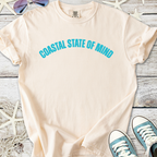 Light beige cotton t-shirt with 'Coastal State of Mind' graphic in turquoise, perfect for casual beachwear.