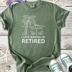Green retired theme t-shirt with palm tree graphic and text 'I Love Waking Up Retired', casual cotton material.