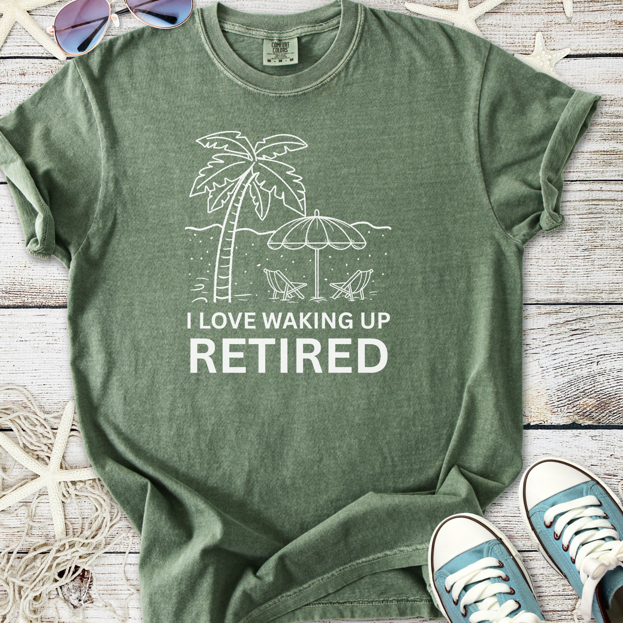 Green retired theme t-shirt with palm tree graphic and text 'I Love Waking Up Retired', casual cotton material.