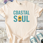 Light beige t-shirt with 'Coastal Soul' graphic and palm tree design, perfect for beach lovers.