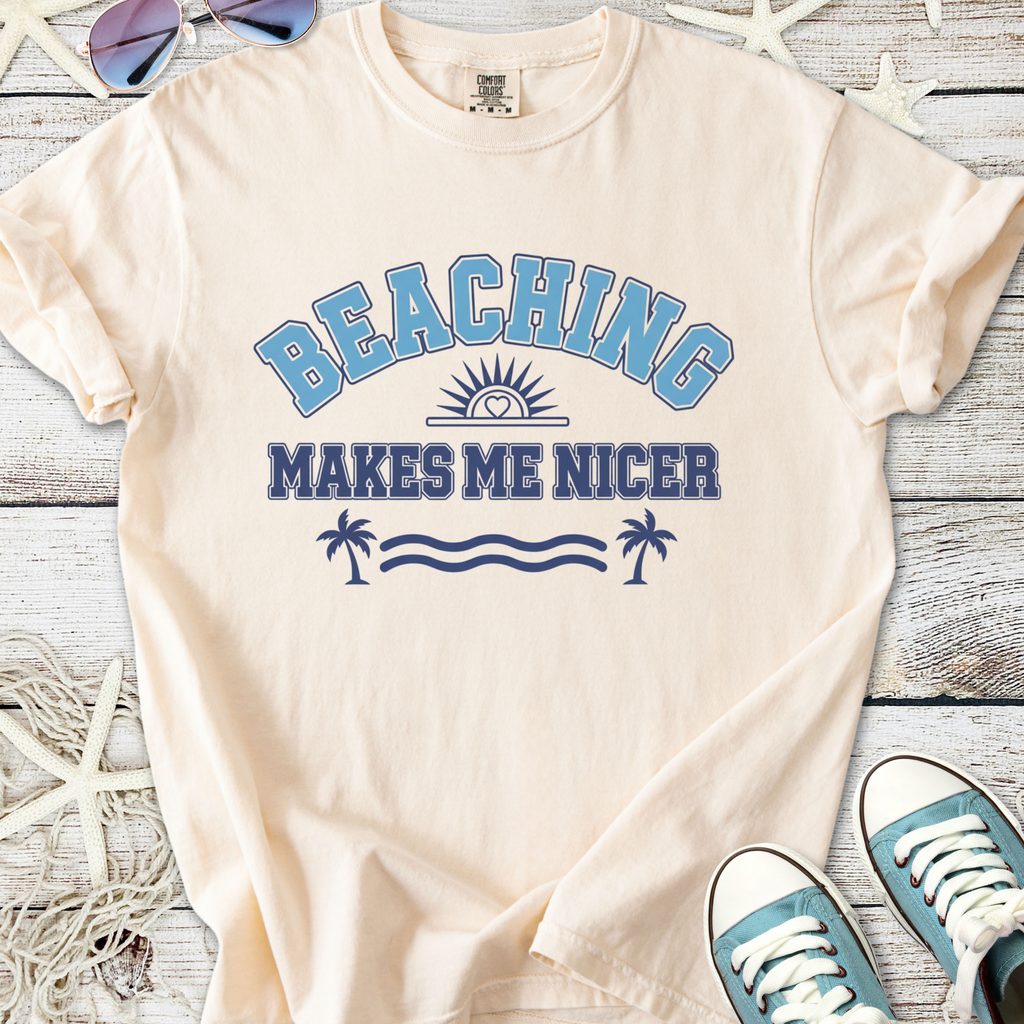 Cream t-shirt with blue graphic 'BEACHING MAKES ME NICER', perfect for summer casual wear.