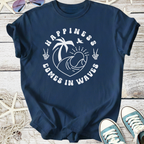 Navy blue graphic t-shirt with 'Happiness Comes in Waves' print; perfect for beach lovers.