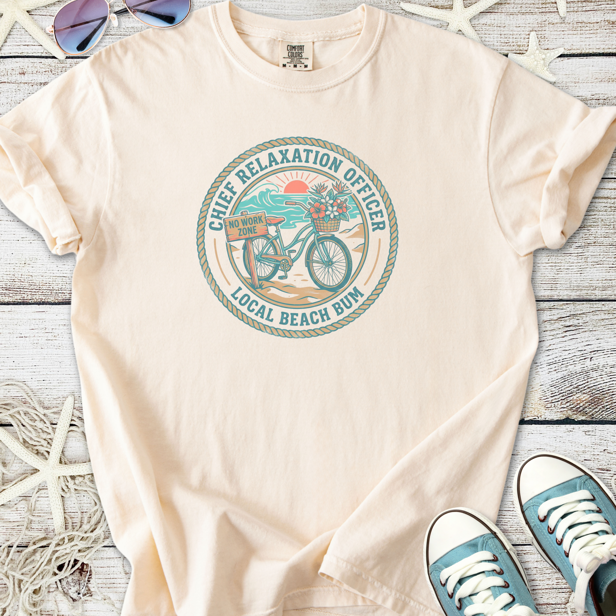 Cream cotton t-shirt featuring 'Chief Relaxation Officer' graphic with beach and bike design.