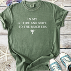 Green cotton t-shirt with 'In My Retire and Move to the Beach Era' print, perfect for beach lovers.