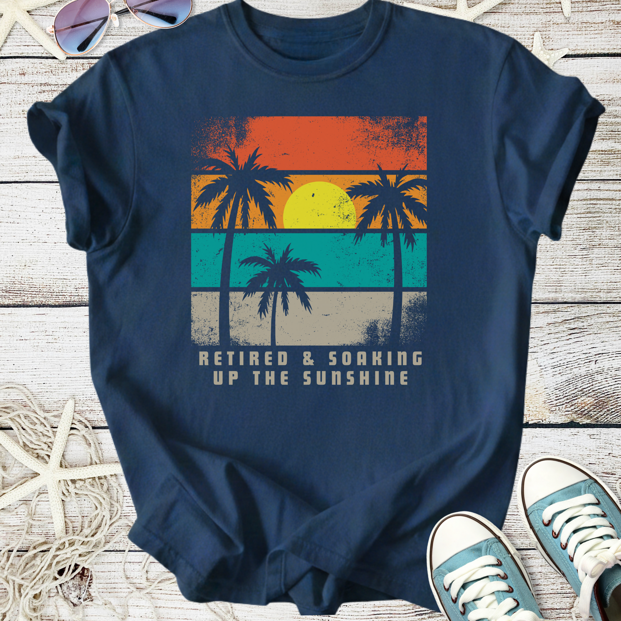 Navy blue t-shirt with retro palm tree graphic, 'Retired & Soaking Up the Sunshine' printed on front.