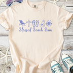 Light beige t-shirt with 'Blessed Beach Bum' graphic in blue, featuring beach icons like a chair and flip-flops.