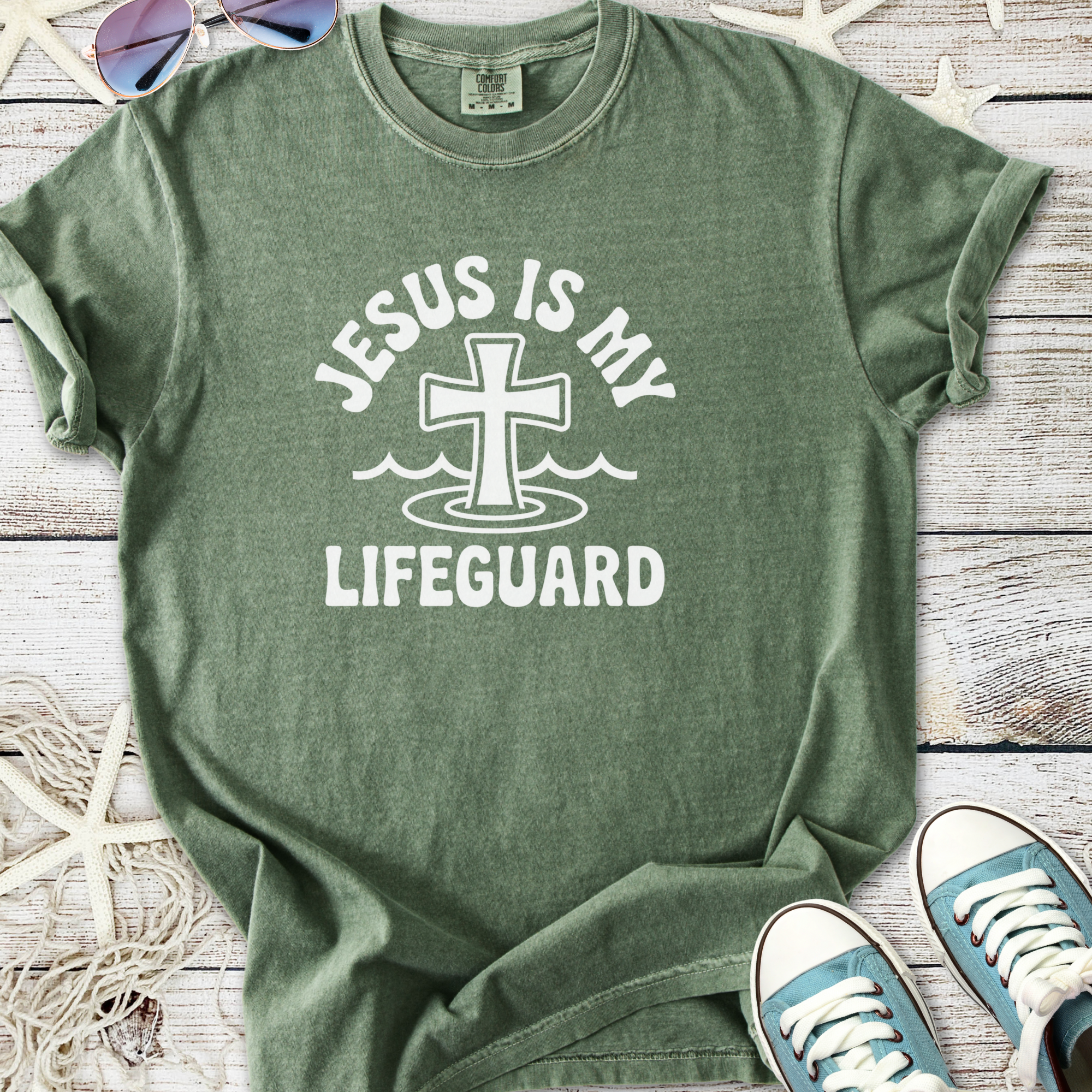 Green t-shirt featuring 'Jesus is My Lifeguard' design, soft cotton material, perfect for casual wear.