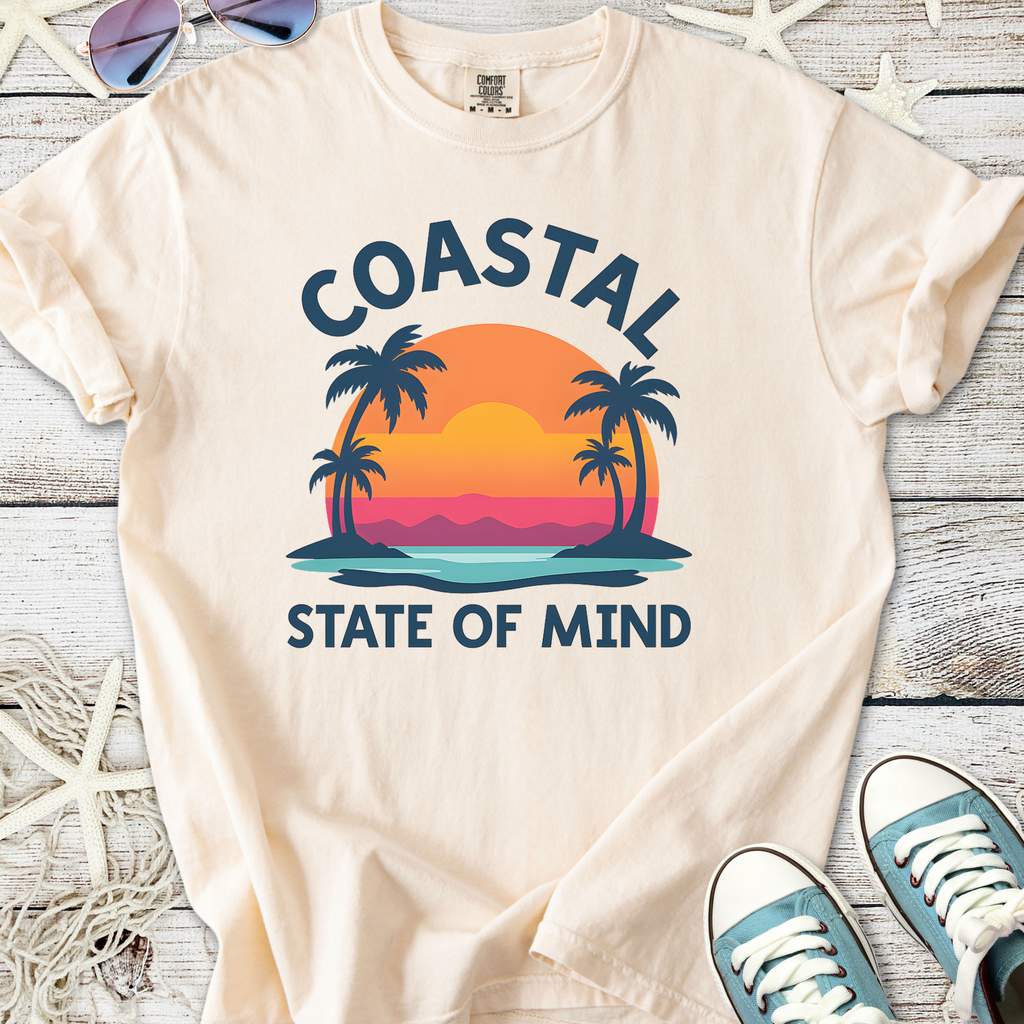 Cream coastal graphic tee featuring sunset, palm trees, and 'State of Mind' print, perfect for beach lovers.
