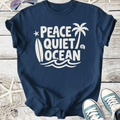 Navy blue t-shirt with 'Peace Quiet Ocean' graphic in white, featuring palm trees and a surfboard design.