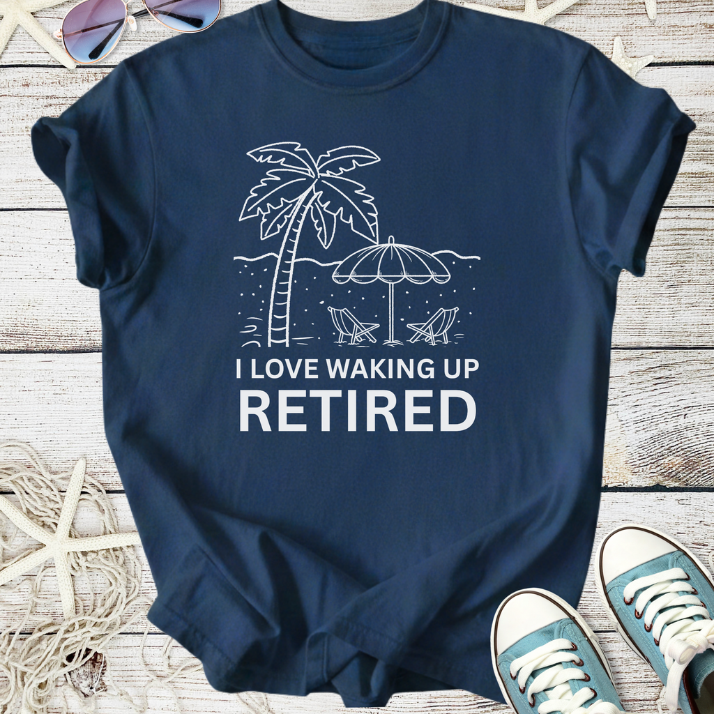Navy blue t-shirt featuring 'I Love Waking Up Retired' graphic with palm tree and beach scene.