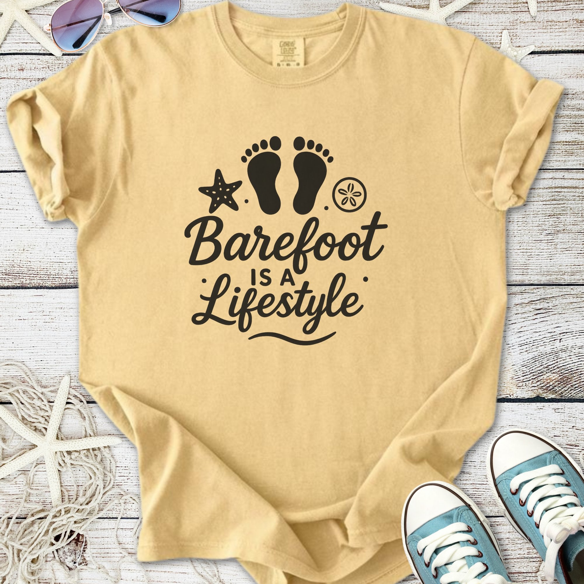 Beige cotton t-shirt with 'Barefoot is a Lifestyle' graphic, starfish, and footprints design.