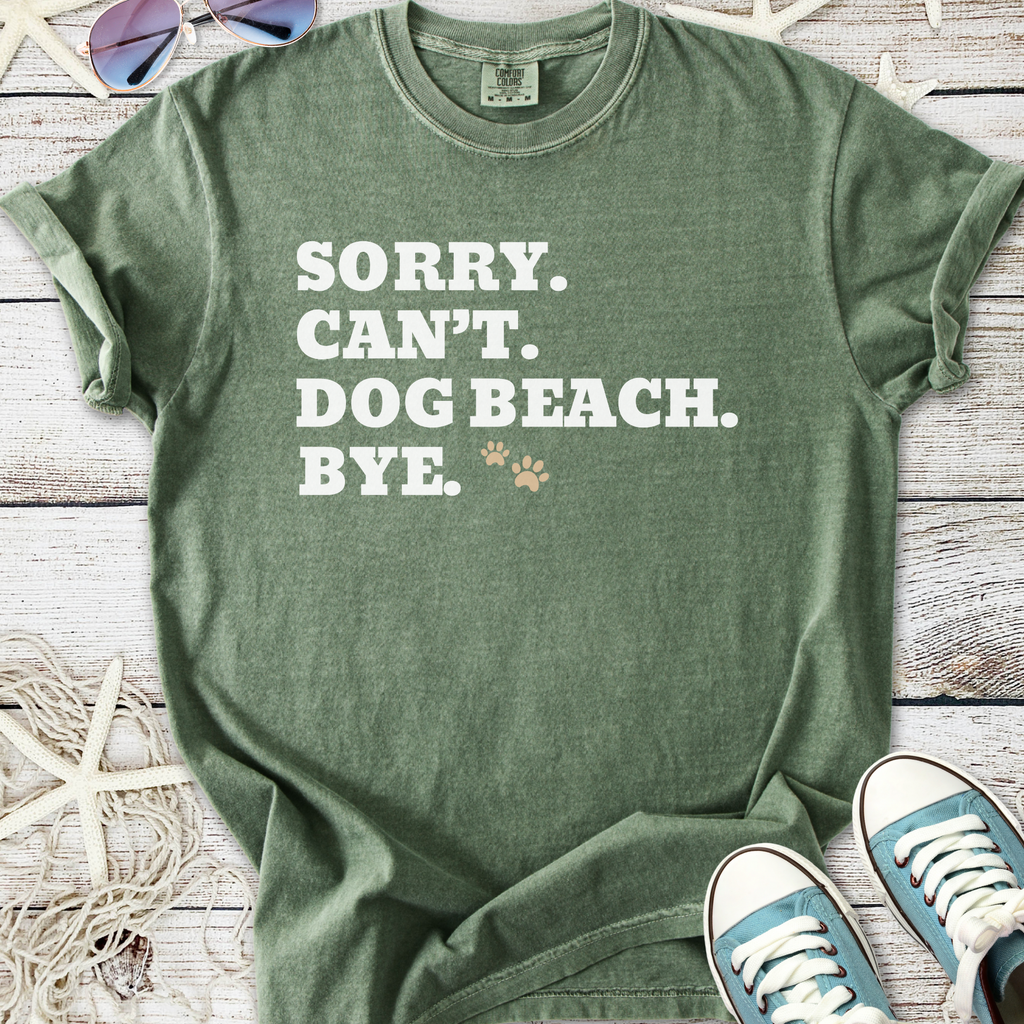 Green unisex t-shirt with funny dog-themed text and paw print, perfect for beach lovers.