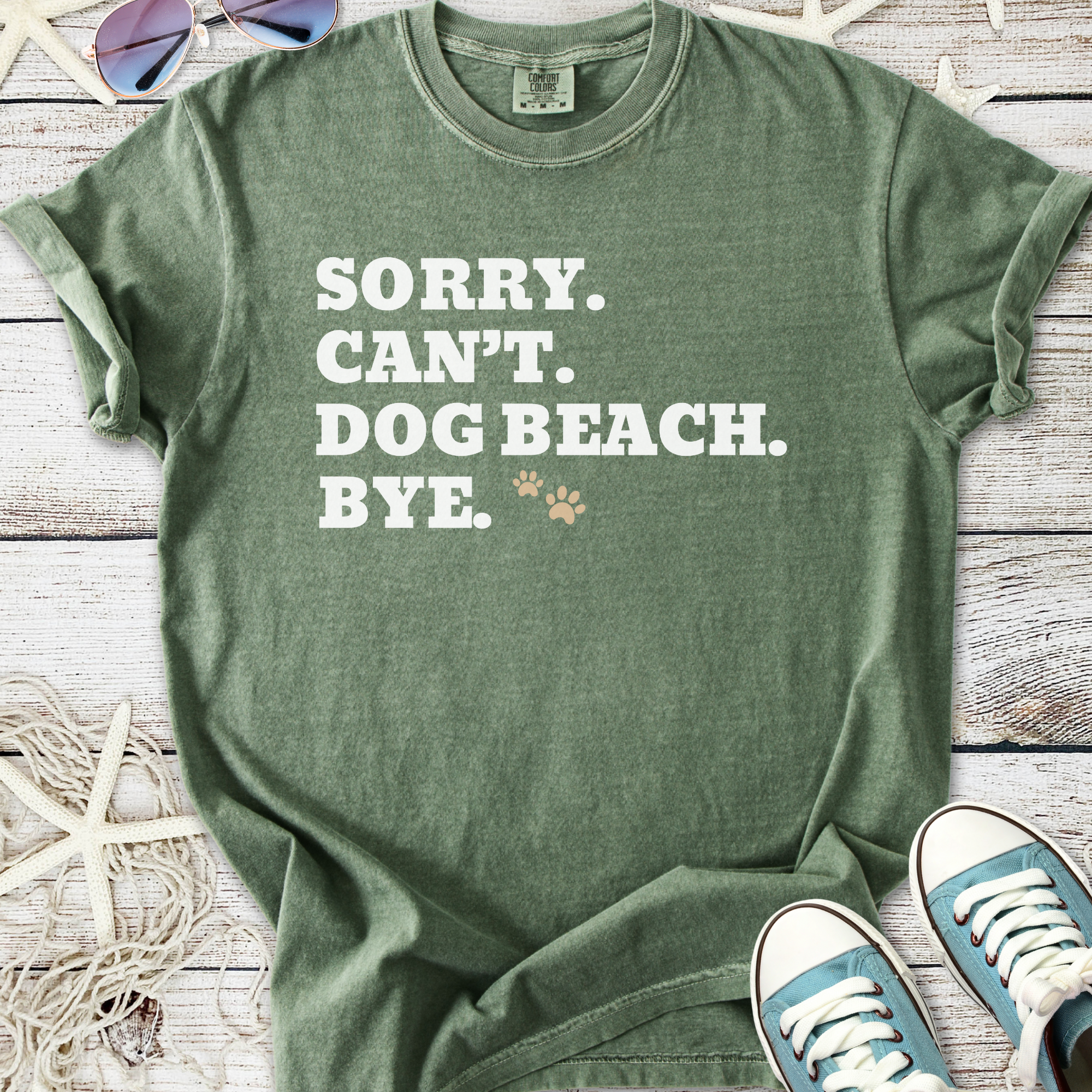 Green unisex t-shirt with funny dog-themed text and paw print, perfect for beach lovers.