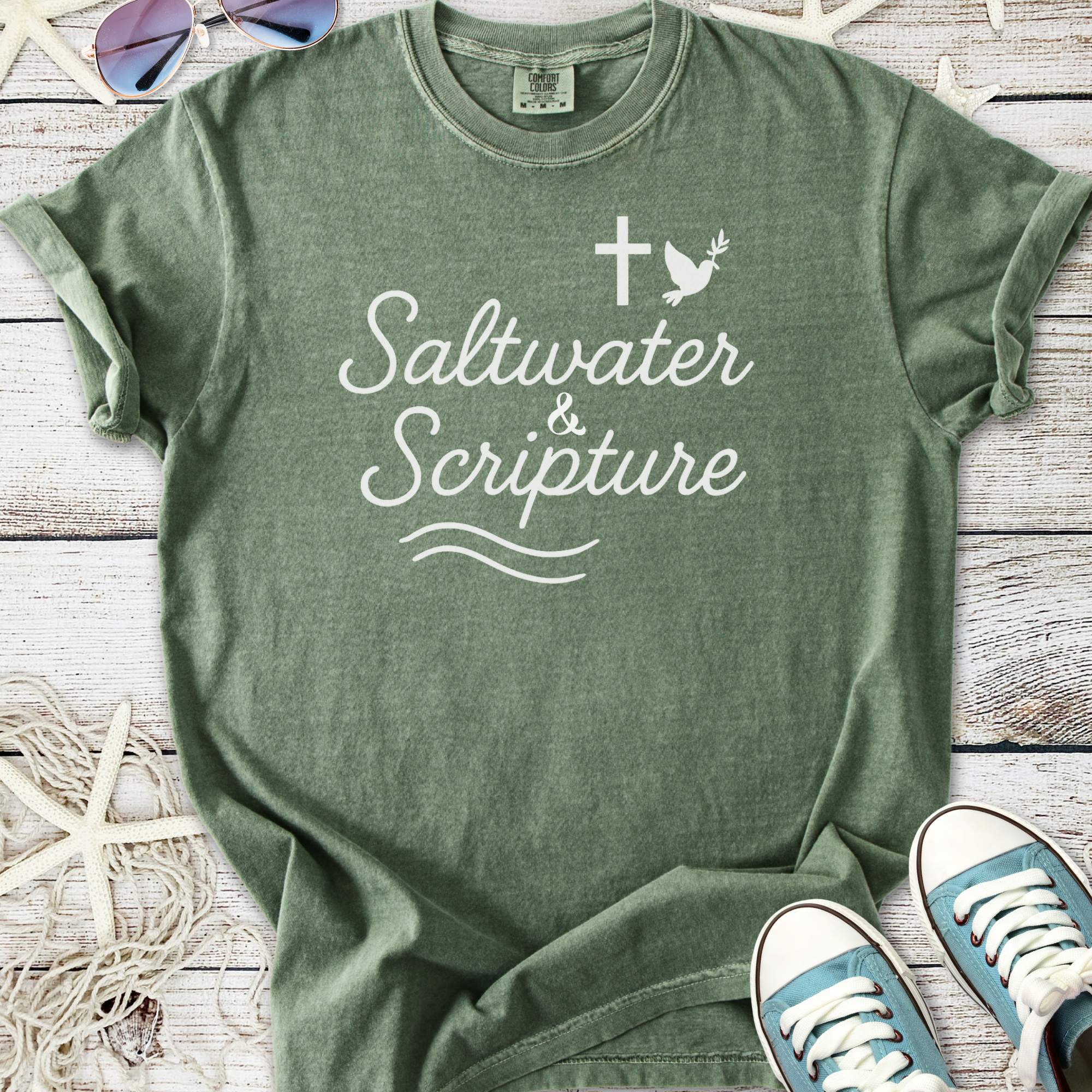 Green cotton t-shirt featuring 'Saltwater & Scripture' design with cross and bird motif.
