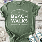 Green cotton t-shirt featuring 'Senior Vice President of Beach Walks' text with paw print design.