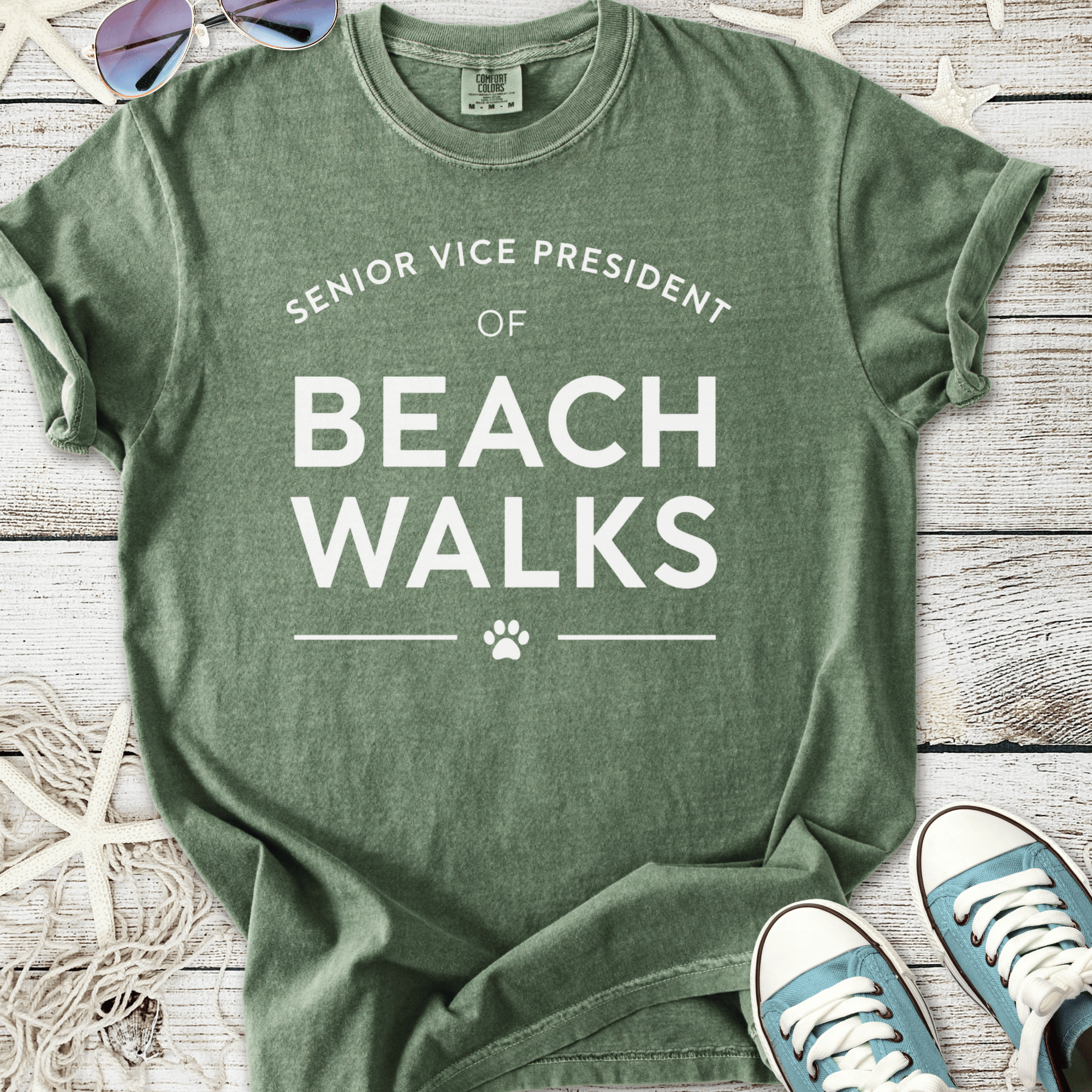 Green cotton t-shirt featuring 'Senior Vice President of Beach Walks' text with paw print design.