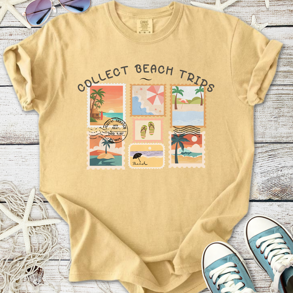 Light yellow t-shirt with 'Collect Beach Trips' design featuring beach-themed stamps.