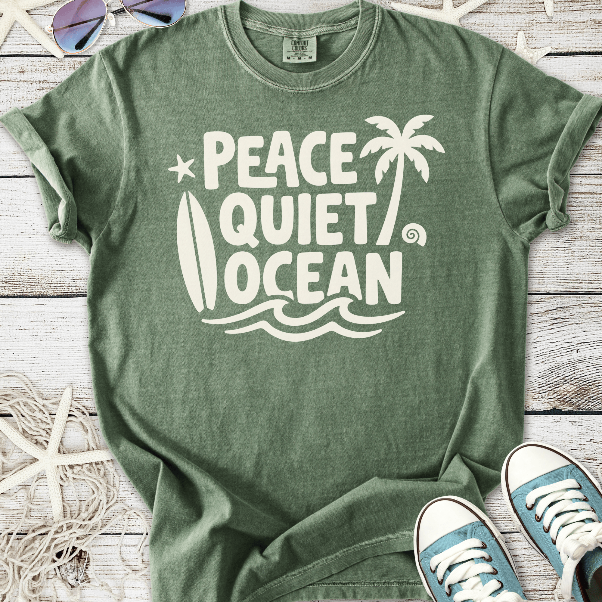 Green unisex t-shirt with 'Peace Quiet Ocean' graphic, made from soft cotton, perfect for beach lovers.