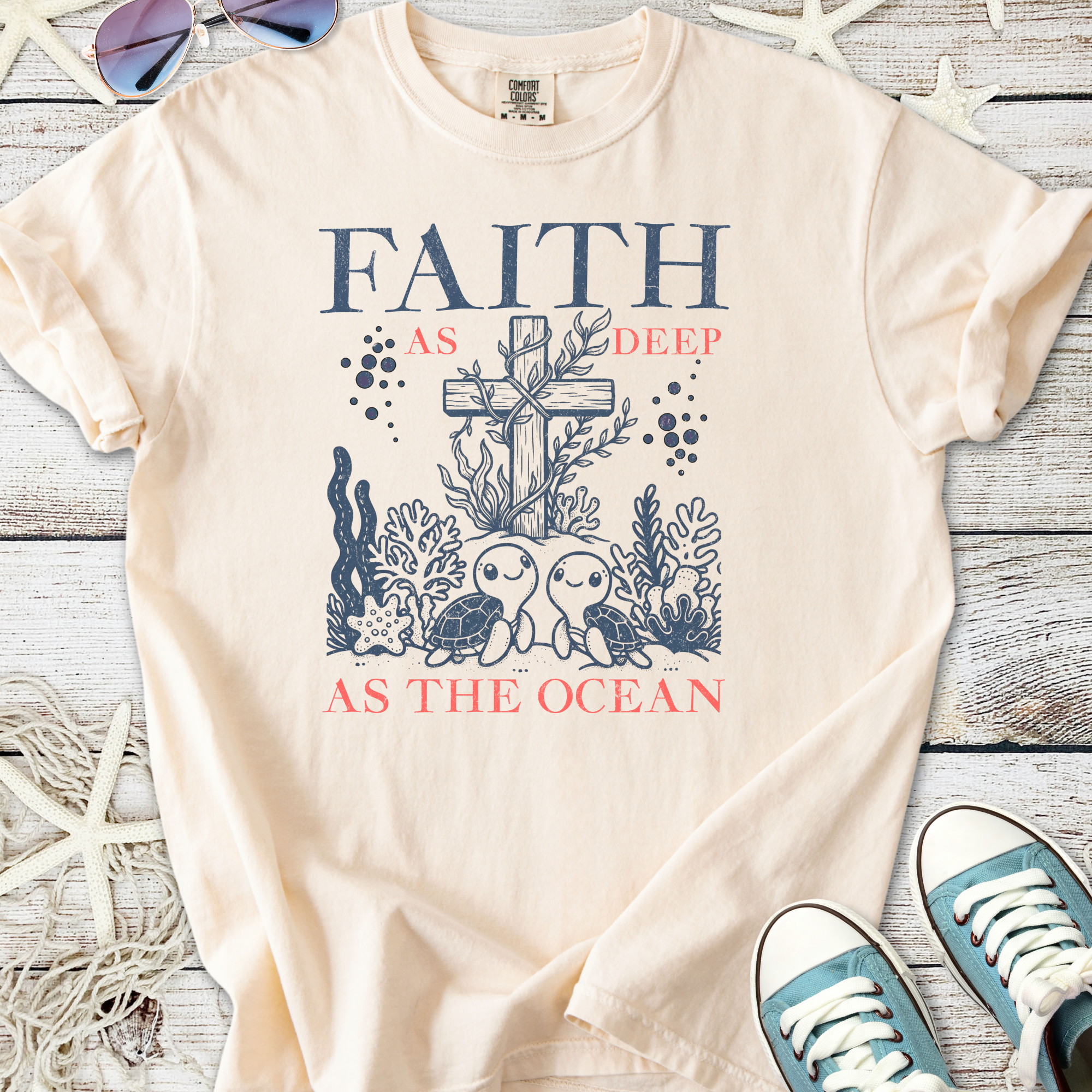Beige cotton t-shirt with 'Faith as deep as the ocean' design featuring turtles and coral.