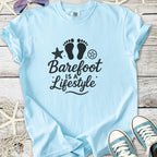 Light blue cotton t-shirt with 'Barefoot is a Lifestyle' graphic, perfect for casual summer wear.