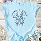 Light blue t-shirt with 'All I Need Is The Beach and My Dog' graphic, featuring beach-themed designs.