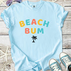 Light blue t-shirt with 'Beach Bum' graphic and palm tree design, perfect for summer wear.