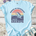 Light blue t-shirt with 'Hooked on Retirement Beach Grandpa' graphic and fishing design.