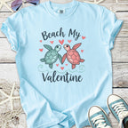 Light blue t-shirt with cute sea turtles and 'Beach My Valentine' design, perfect for Valentine's Day.