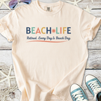 Peach-colored t-shirt with 'BEACH LIFE' graphic, perfect for retirees who love the beach.