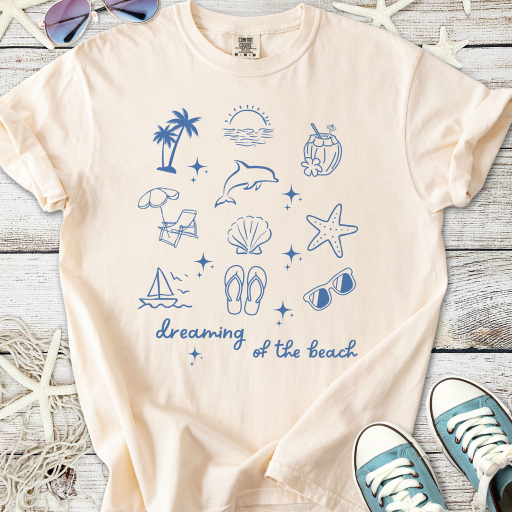 Cream graphic t-shirt featuring beach-themed illustrations in blue, ideal for summer outings.