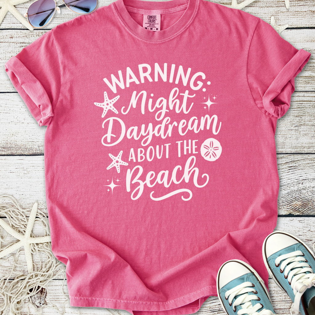 Pink cotton t-shirt with 'Warning: Night Daydream About the Beach' graphic design, perfect for summer.