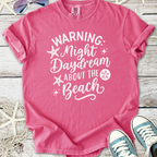Pink cotton t-shirt with 'Warning: Night Daydream About the Beach' graphic design, perfect for summer.