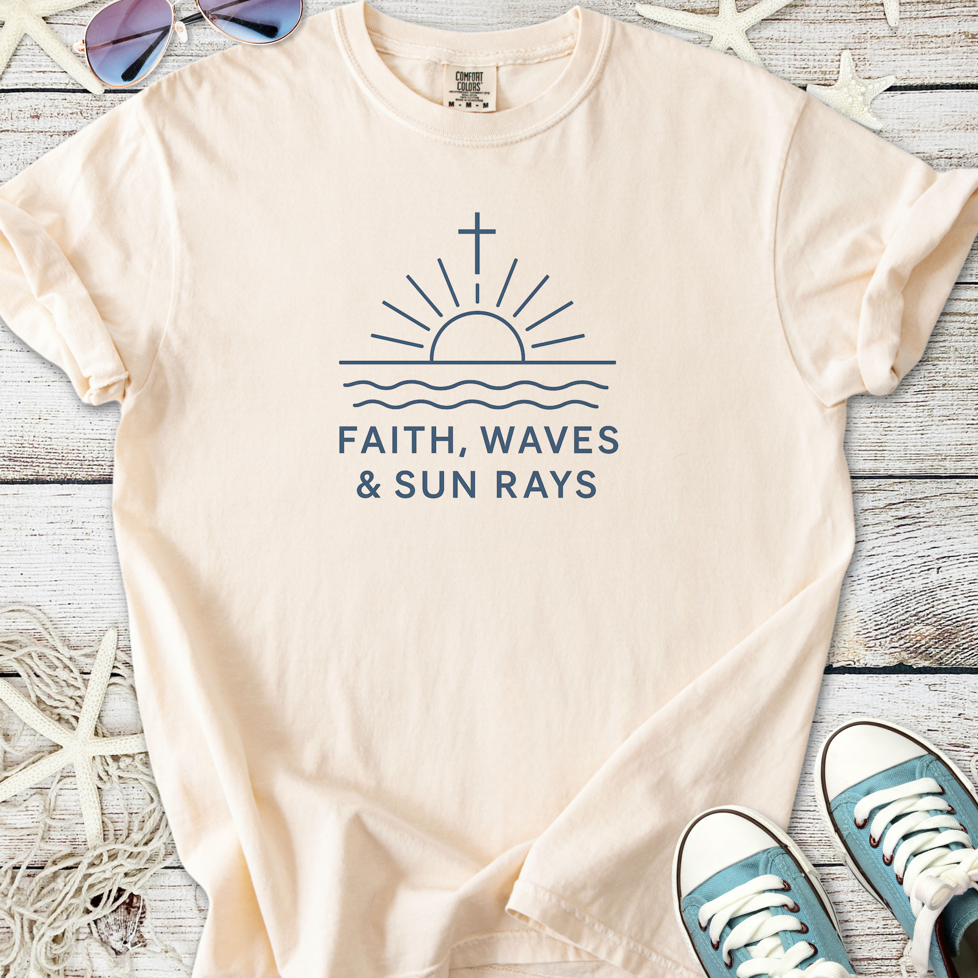 Light beige t-shirt with 'Faith, Waves & Sun Rays' graphic, made from soft cotton for casual summer wear.
