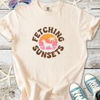 Cream cotton t-shirt with 'Fetching Sunsets' graphic featuring dog and palm tree design.