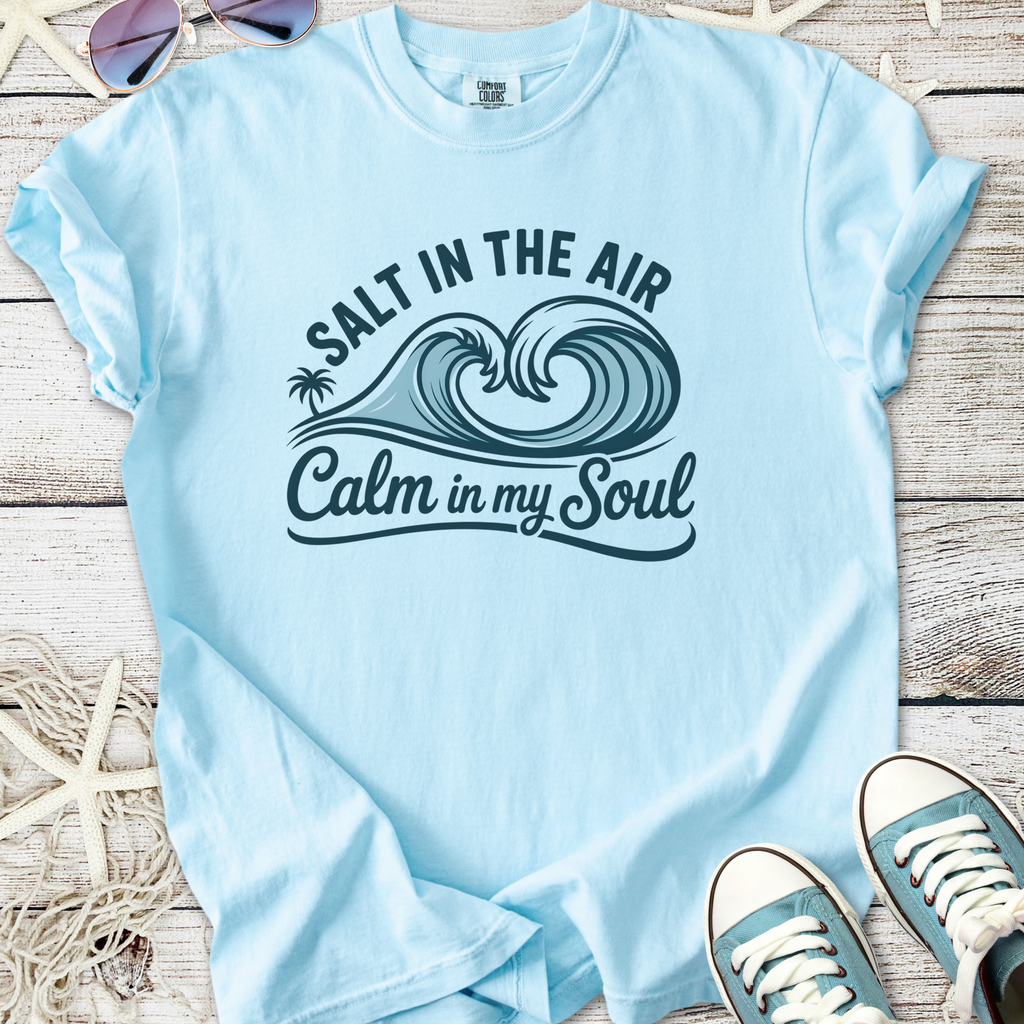 Light blue t-shirt with 'Salt in the Air, Calm in my Soul' graphic design and wave theme.