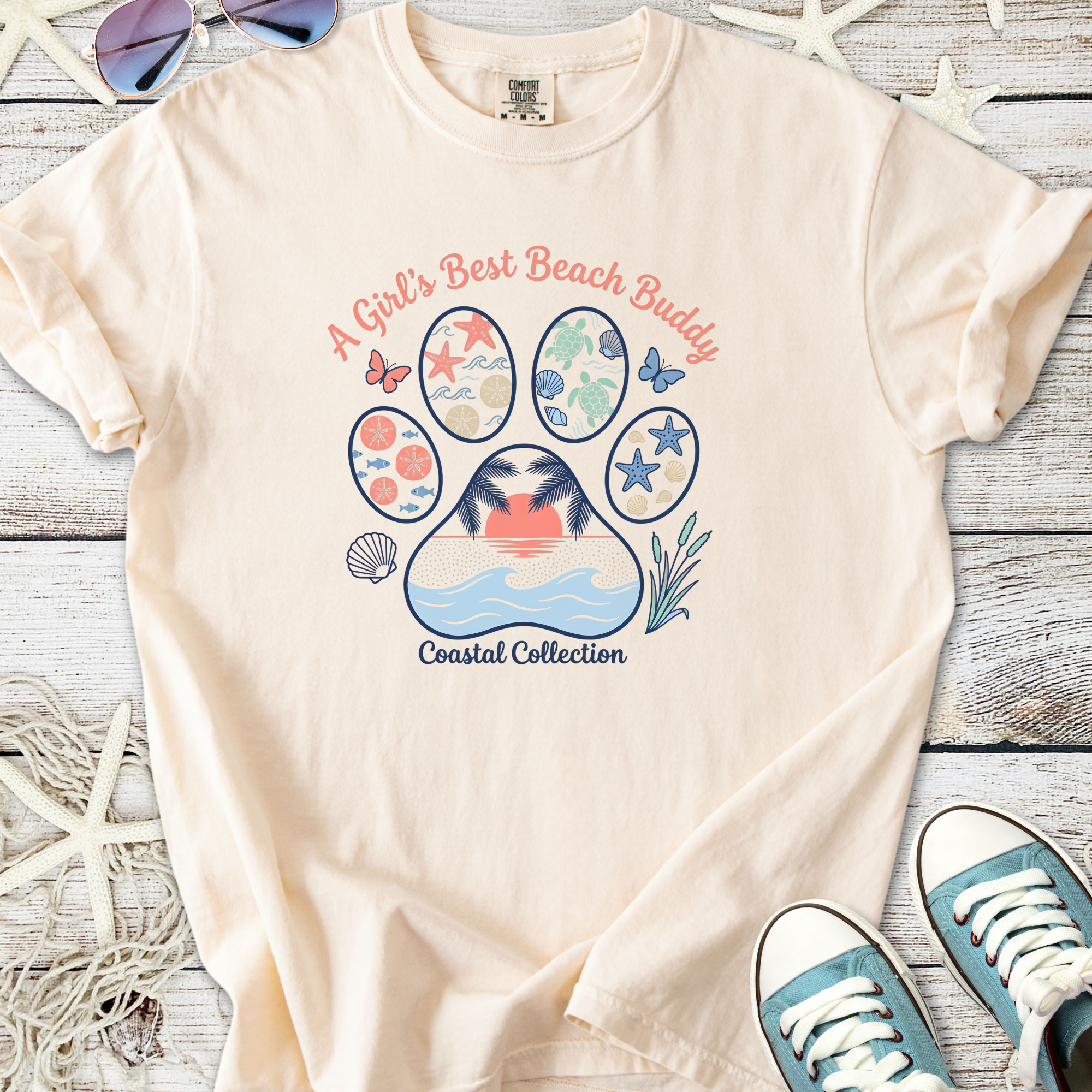 Beige cotton t-shirt with 'A Girl's Best Beach Buddy' graphic, part of the Coastal Collection.
