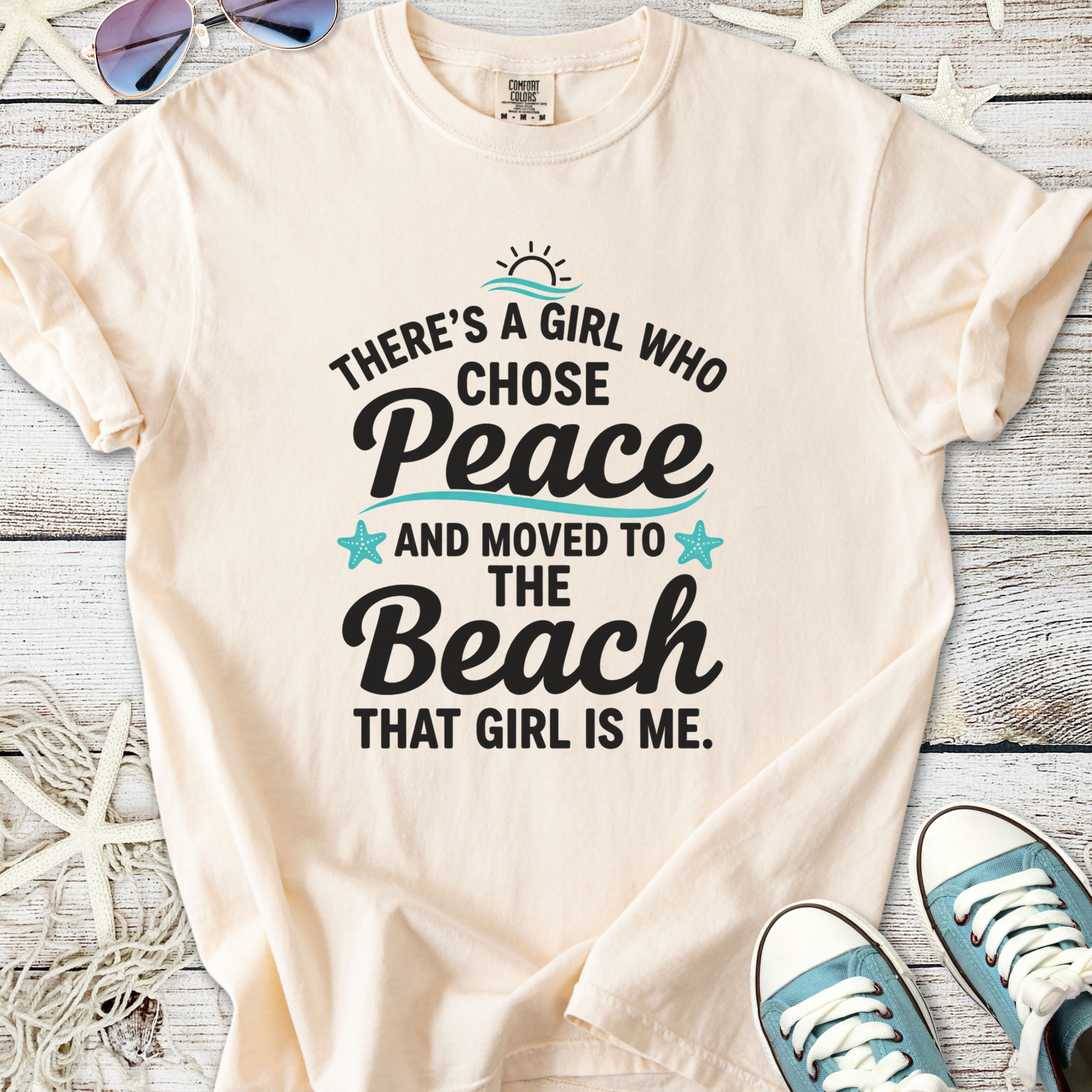 Cream graphic tee featuring beach-themed quote about peace and life by the sea.