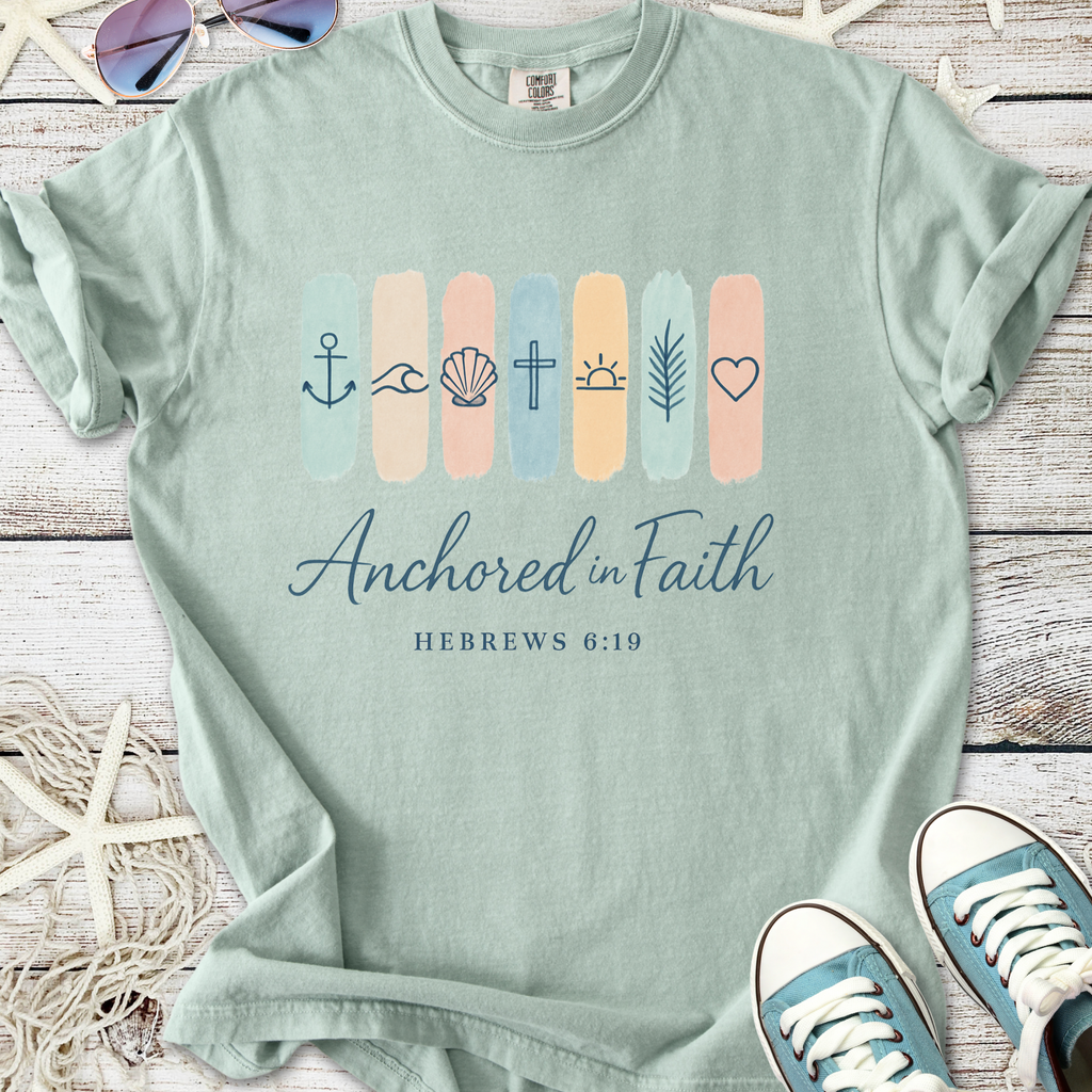 Mint green t-shirt with 'Anchored in Faith' graphic and nautical symbols, perfect for casual wear.