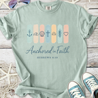 Mint green t-shirt with 'Anchored in Faith' graphic and nautical symbols, perfect for casual wear.