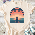 Cream t-shirt featuring a sunset dog silhouette design with palm trees, perfect for casual wear.
