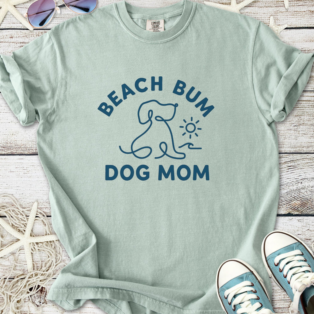 Light green t-shirt featuring 'Beach Bum Dog Mom' print, perfect for dog lovers and beach enthusiasts.