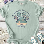 Mint green t-shirt with beach-themed paw print design, text: 'All you need is beach therapy and a dog'