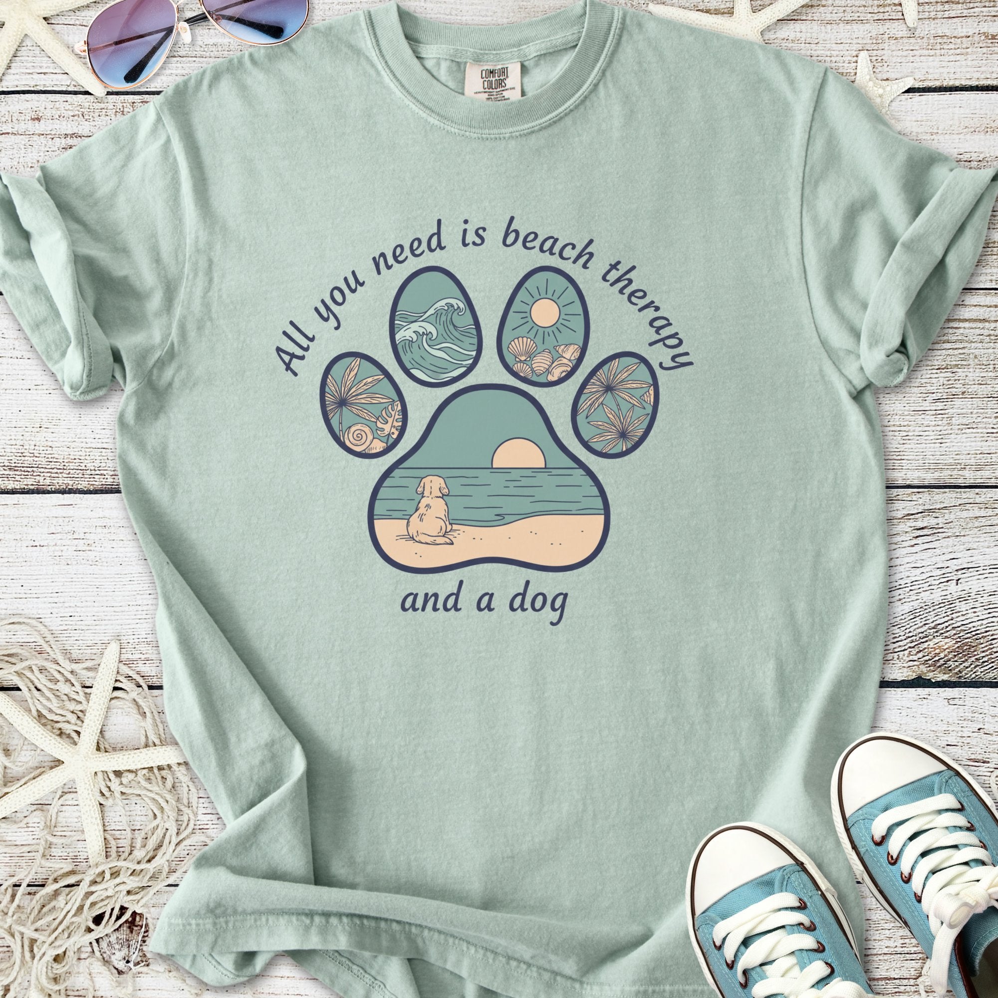 Mint green t-shirt with beach-themed paw print design, text: 'All you need is beach therapy and a dog'