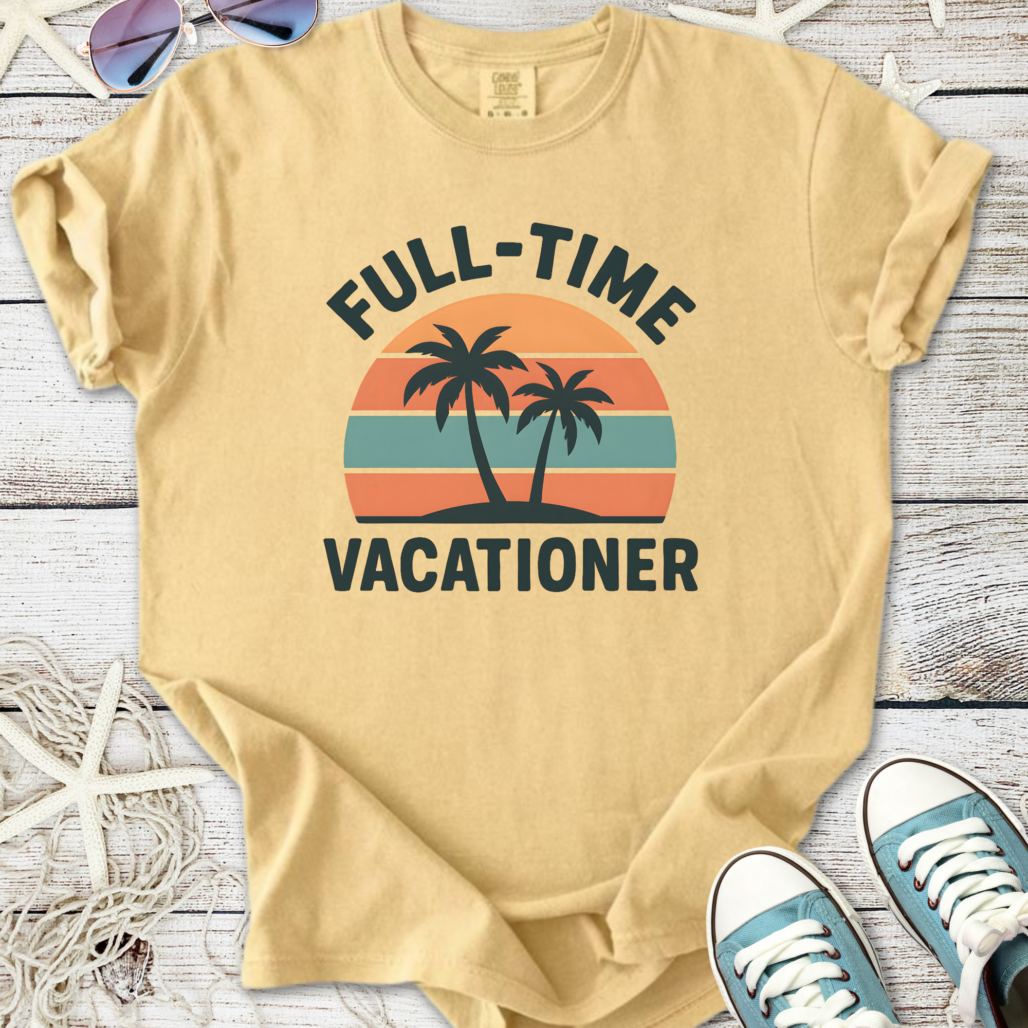 Light beige t-shirt with 'Full-Time Vacationer' graphic, featuring palm trees and sunset stripes.