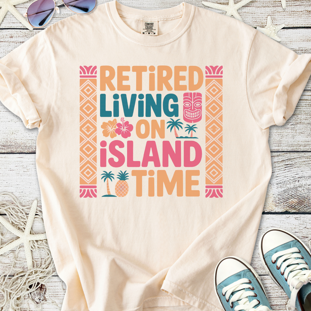 Cream t-shirt with colorful 'Retired Living on Island Time' graphic, perfect for beach lovers.
