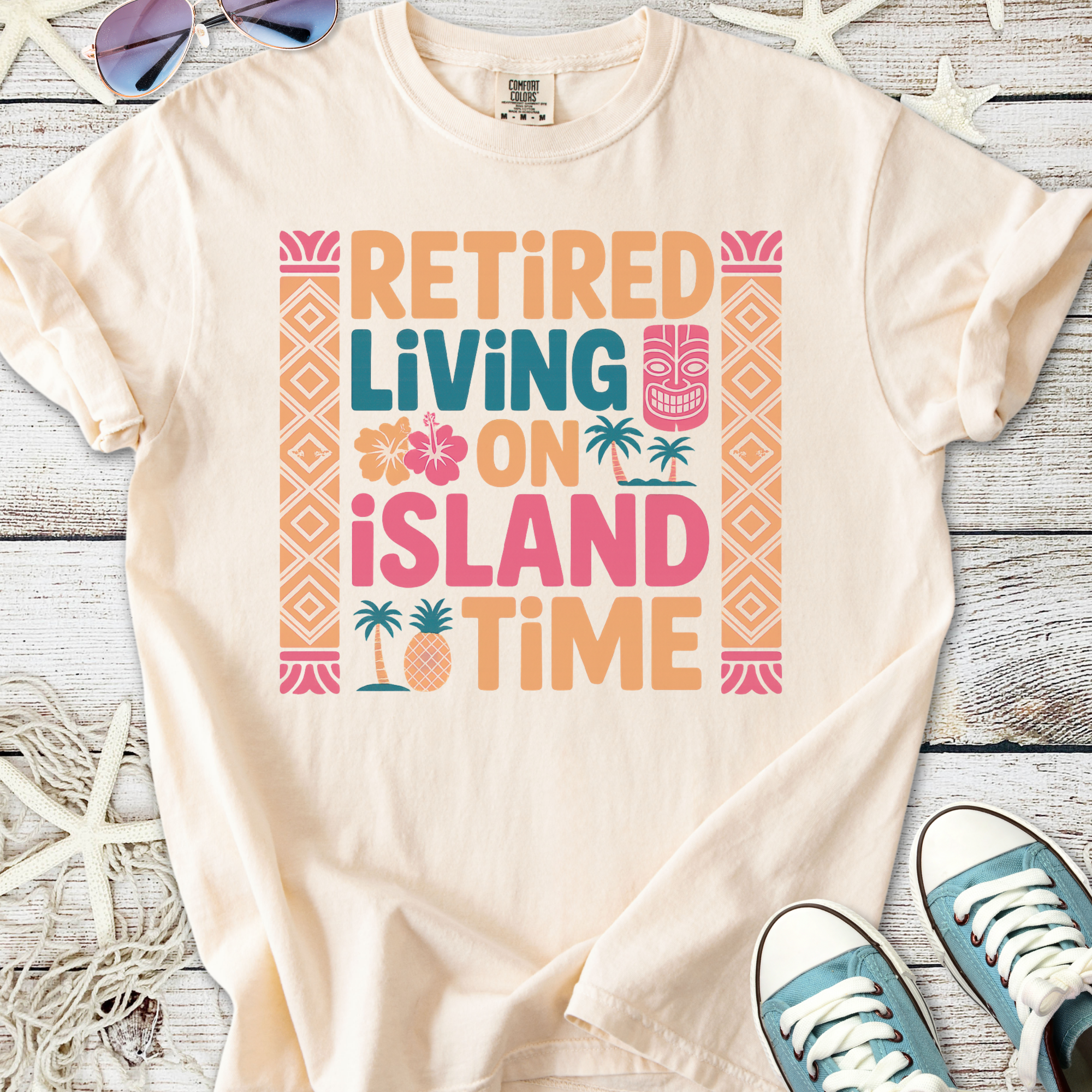 Cream t-shirt with colorful 'Retired Living on Island Time' graphic, perfect for beach lovers.
